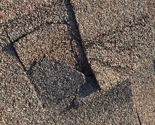 Damaged shingles on a home.
