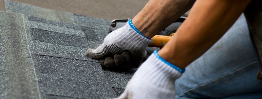 A roofer, as opposed to a team of roofing contractors or a roofing company, installs shingles on a residential property.