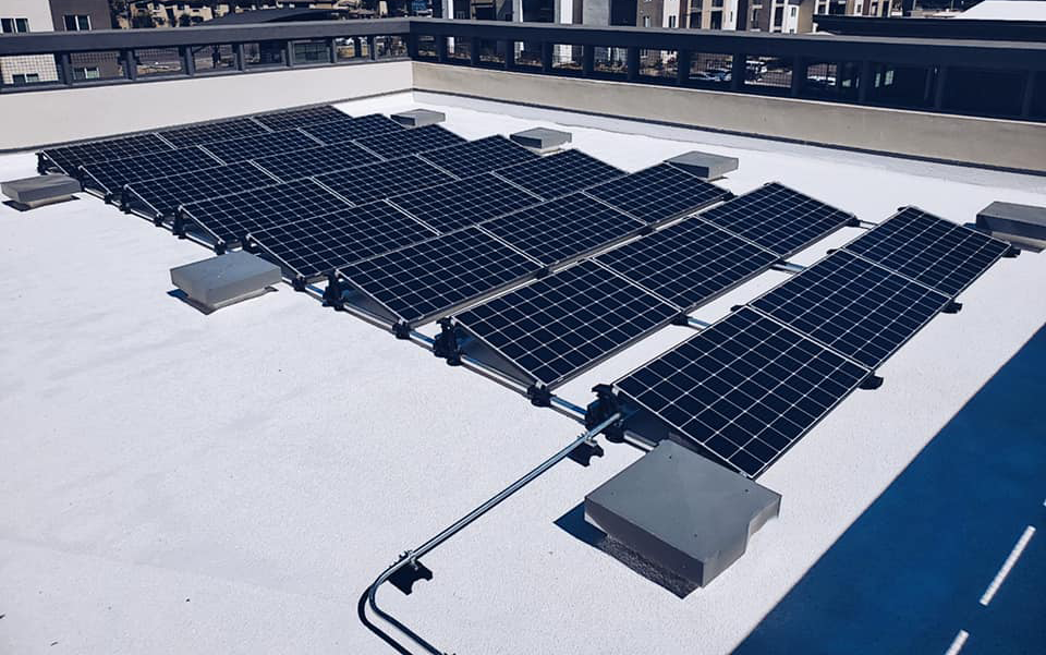 A commercial building roof with solar panels installed