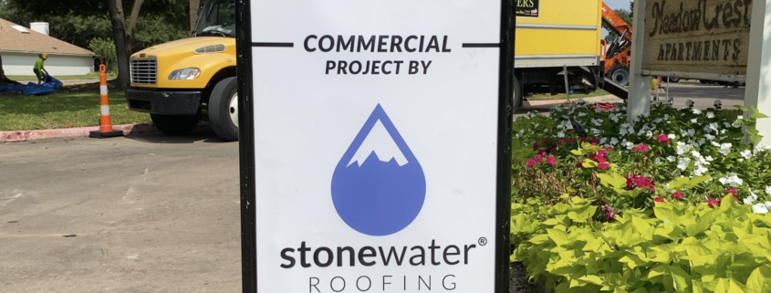 A commercial roofing sign from Stonewater Roofing in Dallas, Texas.