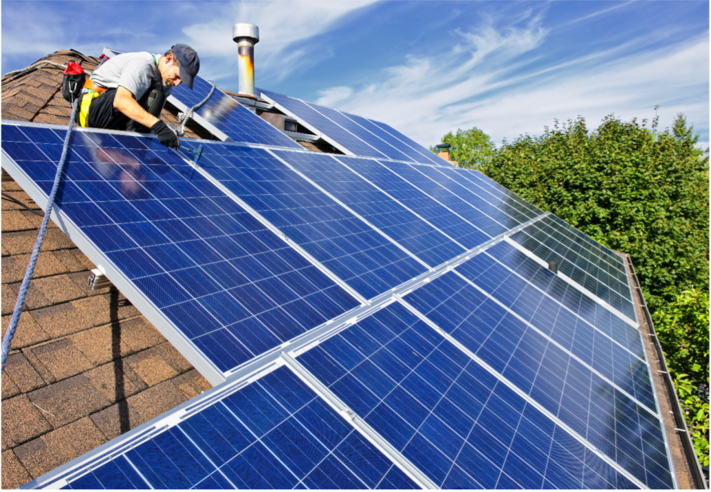 A roofing contractor installing solar panels