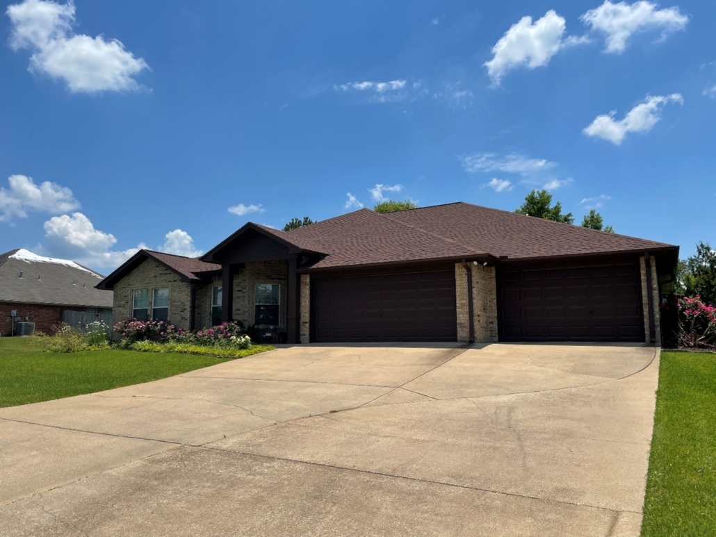 A brick home that has had a roof replacement