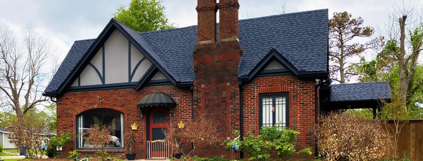 Dark architectural shingles contrast beautifully with a house’s brick exterior