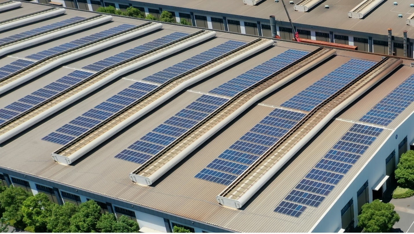 Solar panels installed on the roof of a large commercial facility.
