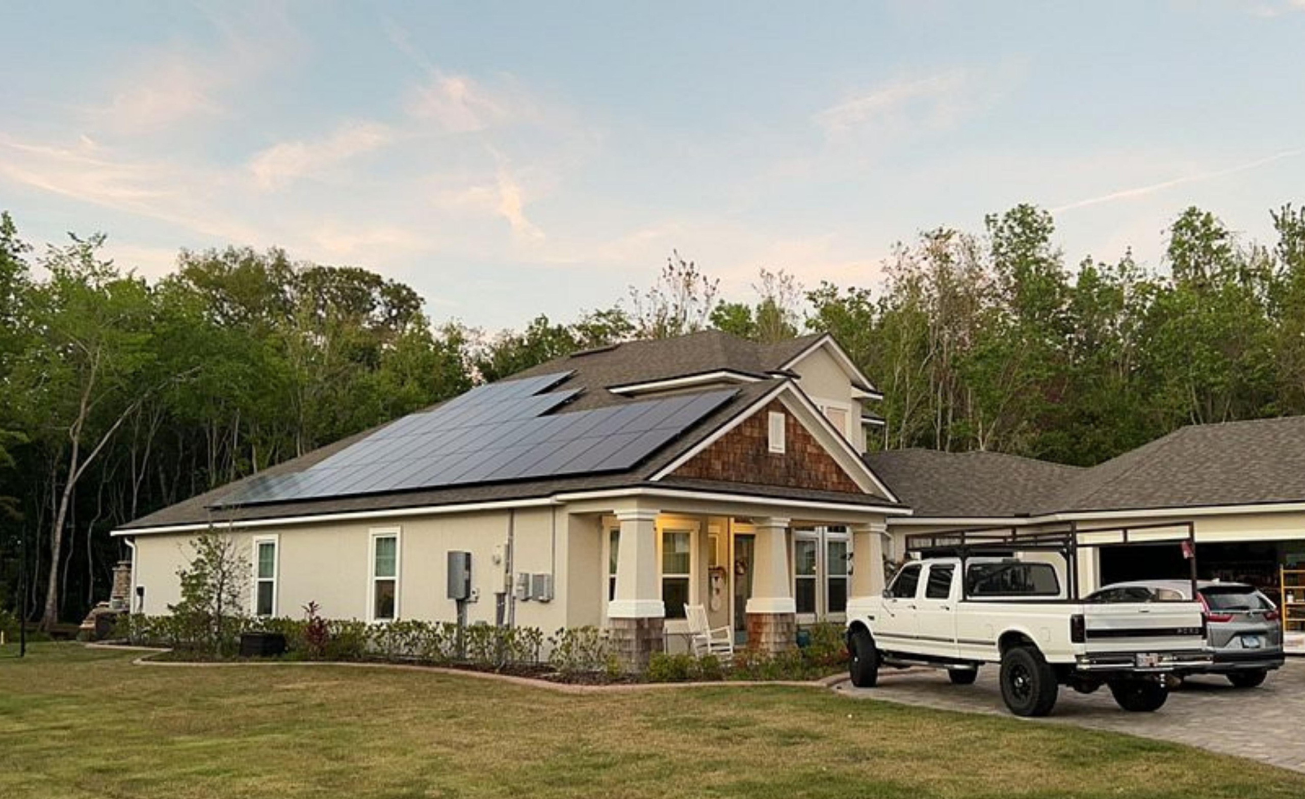 Clean solar panels on a large house at dusk