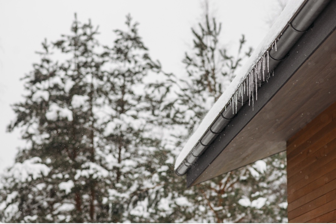 Ice dam forming on the edge of a roof – a sign of potential damage
