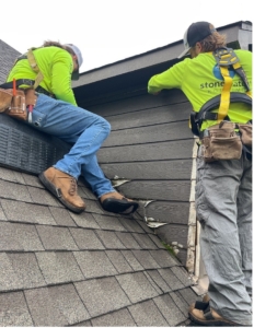 Men on top of a house replacing the roof