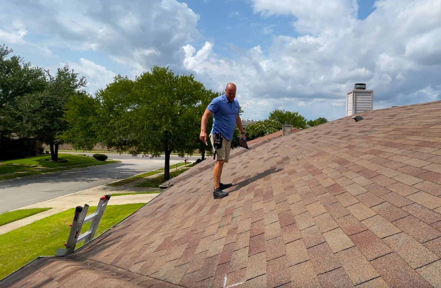A roofing contractor assesses for damage in a professional roof inspection.