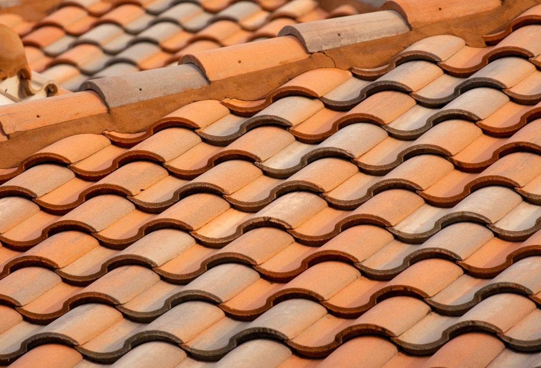 A well-maintained tile roof with no visible signs of wear and tear due to regular roof maintenance