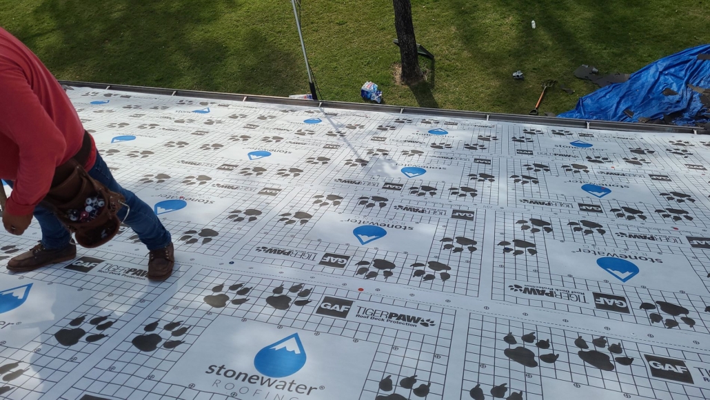 Stonewater roofers replace a residential roof in East Texas. They’ve removed all the shingles from the roof and are about to replace them with new roofing materials.