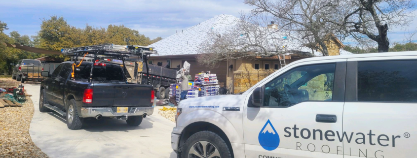 A group of three roofers performs repairs on a home in East Texas.